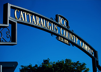 A wrought-iron arch over an entrance to SUNY JCC that says "Cattaraugus County Campus." 