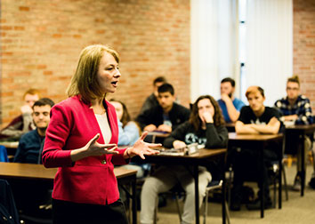 A woman speaks to a class