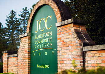 A brick wall emblazoned with SUNY JCC stands at the entrance of the Jamestown Campus.
