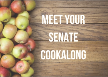 Apples line the left side of a wooden table top with the words "Meet Your Senate Cookalong" to the right.