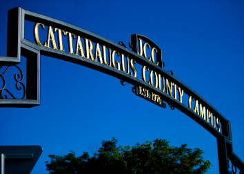 A wrought iron overhead sign welcoming people to JCC that says Cattaraugus County Campus.