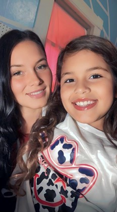 A mother poses for a photo with her daughter.